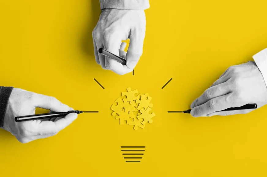 Image of 3 hands and yellow puzzle pieces