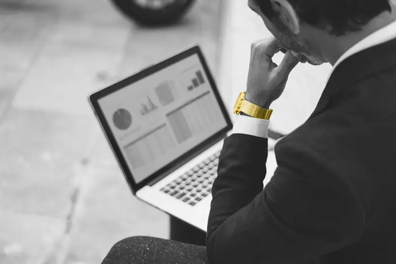 Image of a man looking at a laptop