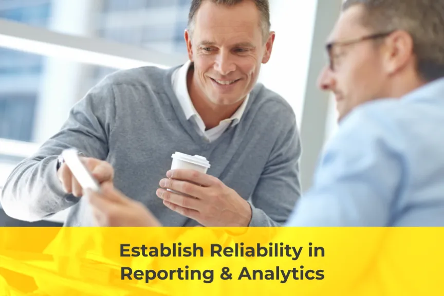 Two men smiling over a report