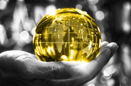 A hand holding a yellow globe