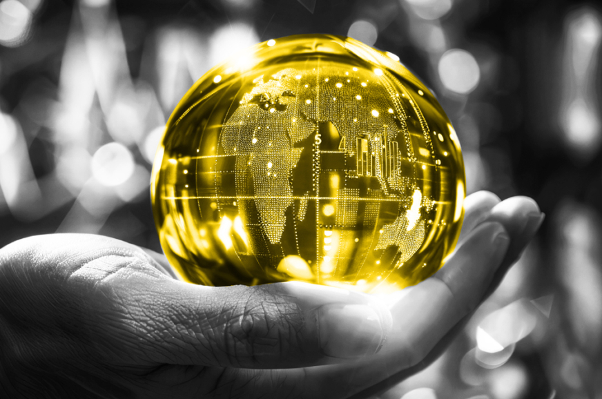 A hand holding a yellow globe