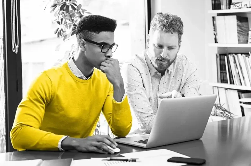 Two guys looking at a laptop